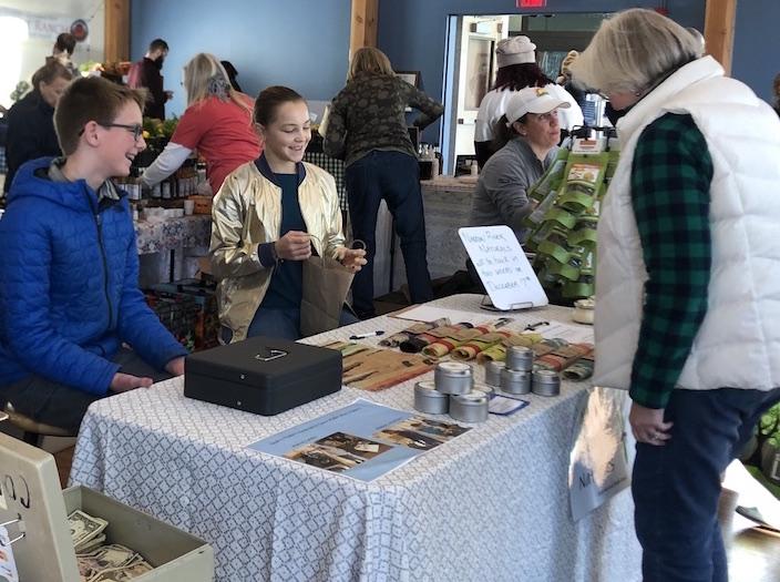Students Selling Narrow River Naturals at the Farmers Market Quest Middle School: More than Academics